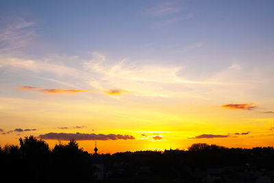 Silhouette trees against sky during sunset