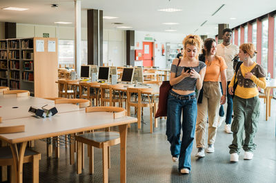 Portrait of female friends standing at airport