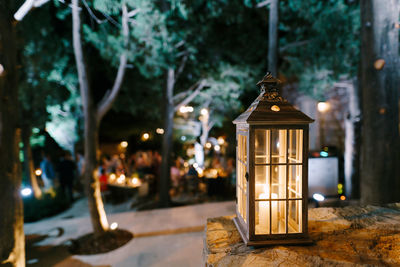 Illuminated lantern on street at night