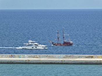 Ship sailing on sea against clear sky