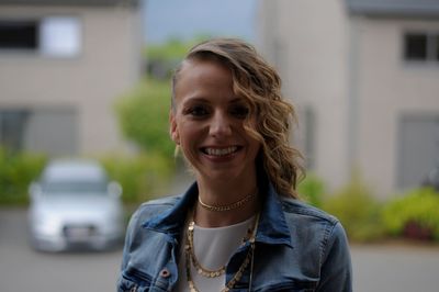 Portrait of smiling woman in city