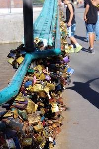 Padlocks on railing by street in city