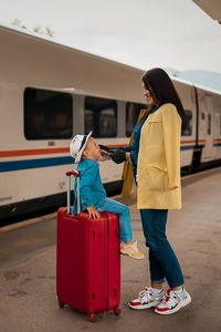 Rear view of women standing on train