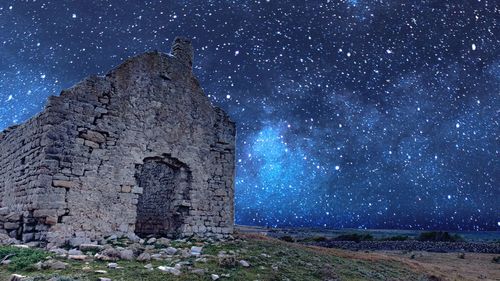 Old ruins against sky at night