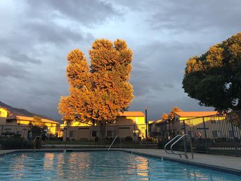 River by swimming pool by buildings against sky