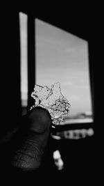 Close-up of hand holding glass window