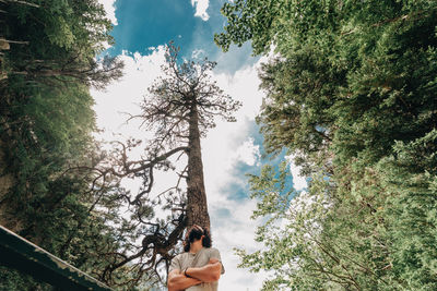 Man and woman against trees against sky