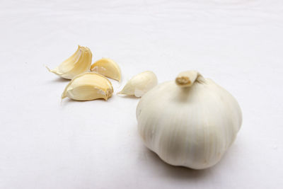 Close-up of garlic on white background