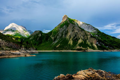 Scenic view of lake and mountains against sky