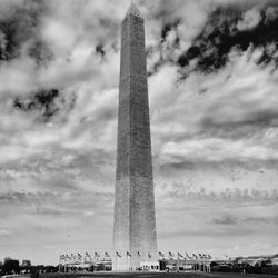 Low angle view of tower against cloudy sky