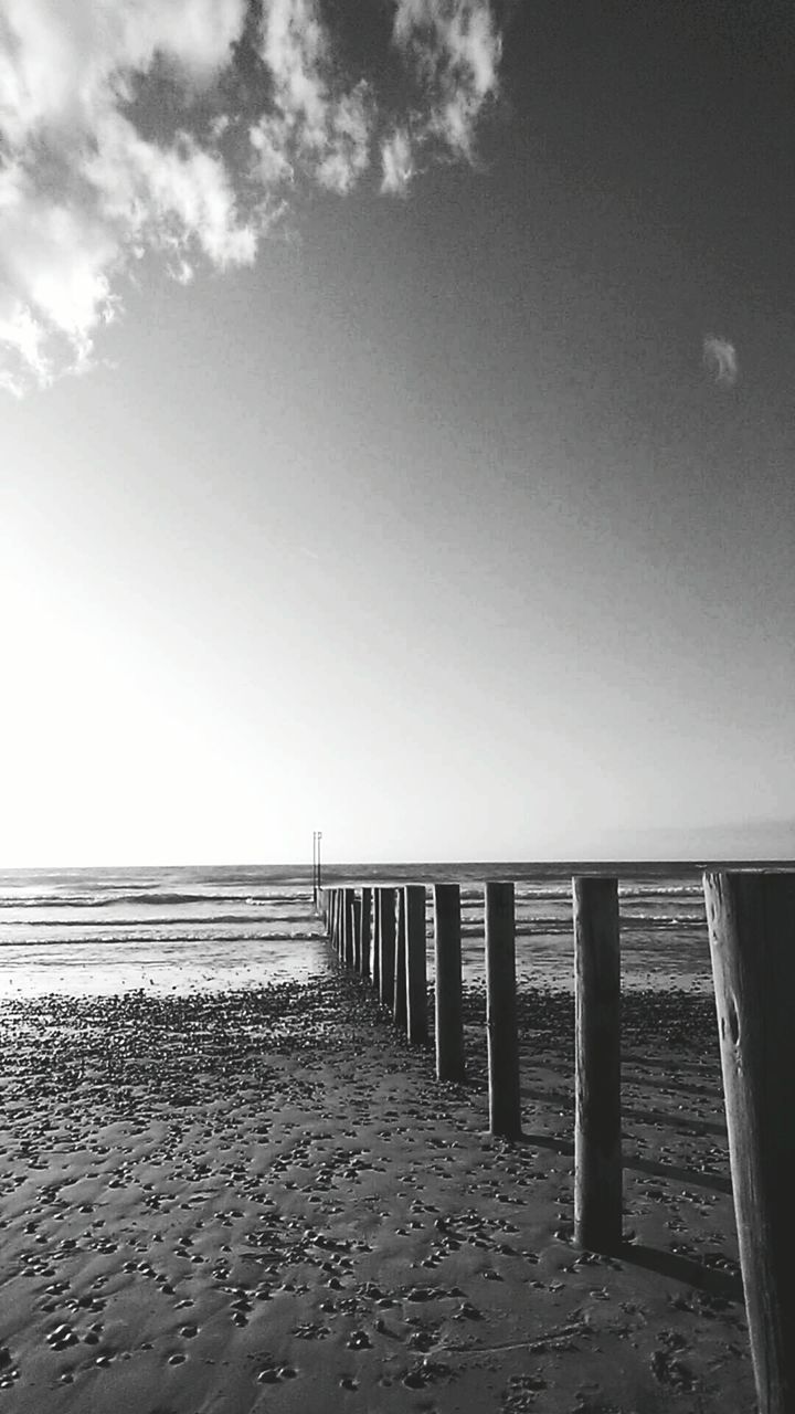 beach, sea, horizon over water, sand, water, shore, sky, tranquility, tranquil scene, pier, scenics, nature, beauty in nature, built structure, railing, wood - material, idyllic, day, calm, outdoors