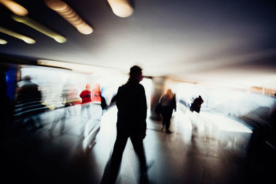 Group of people walking in corridor