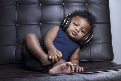 Portrait of young woman sitting on sofa