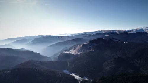 Scenic view of snowcapped mountains against clear sky