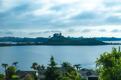 Scenic view of sea by buildings against sky