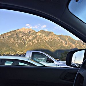 Cars on mountain seen through car windshield