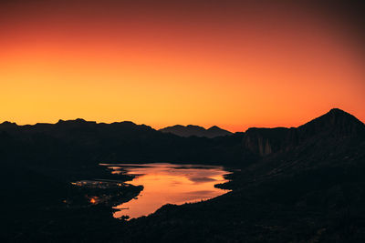 The light of the sunset illuminates the walls and water of canyon lake outside phoenix, arizona.