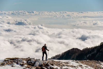 Man standing on mountain against sky