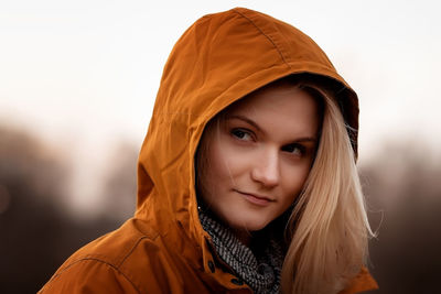 Portrait of young woman wearing hijab against white background