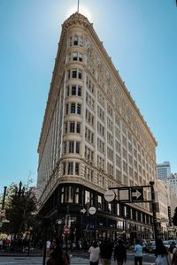 People on street against buildings in city