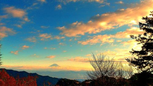 Scenic view of mountains against cloudy sky