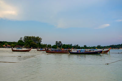 Boats in sea against sky