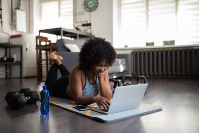 African american woman using laptop during training