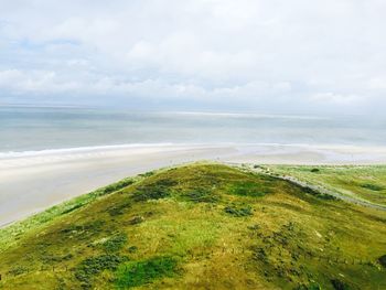 Scenic view of sea against cloudy sky