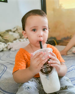 Portrait of young girl drinking milktea