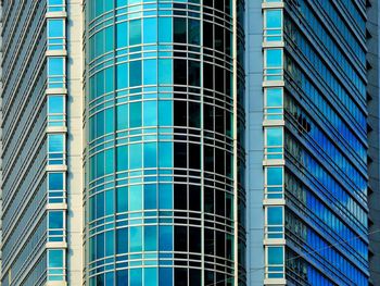 Low angle view of office building against blue sky