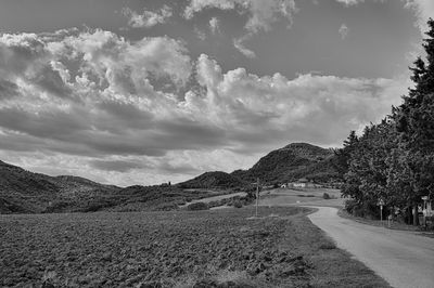 Road amidst trees against sky