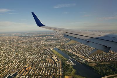 Cropped image of airplane wing against sky