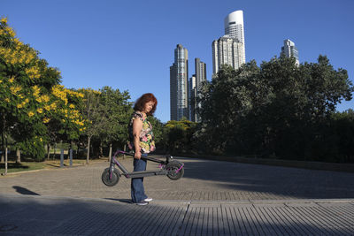 Rear view of woman sitting on street