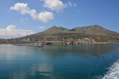 Scenic view of sea and mountains against sky