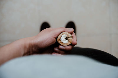 Close-up of man holding a nut 