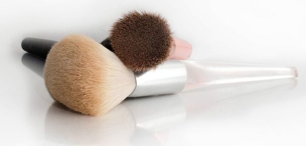 Close-up of make-up brushes on white background