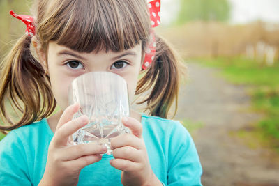 Close-up of woman drinking water