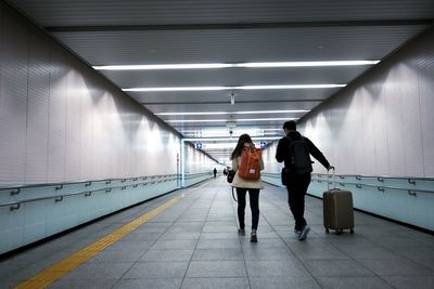 Rear view of people on escalator