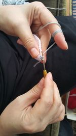 Cropped image of woman crocheting at home