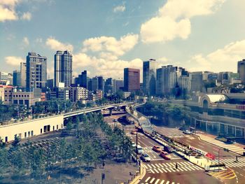 High angle view of street amidst buildings in city against sky