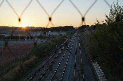High angle view of railroad tracks against sky during sunset