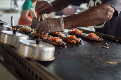 Close-up of man preparing food