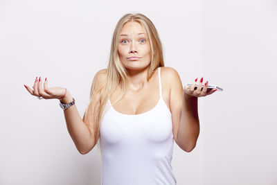 Portrait of beautiful young woman against white background