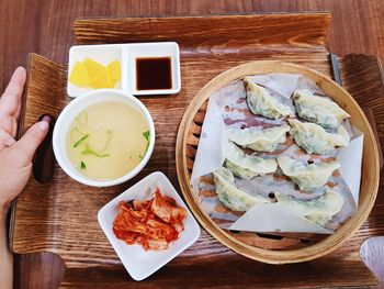 Cropped hand having food in restaurant