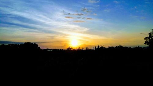 Silhouette landscape against sky during sunset