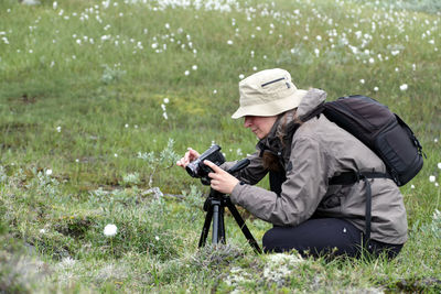 Woman using mobile phone in grass