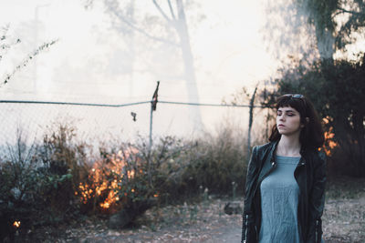 Portrait of woman standing against plants