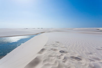 Scenic view of beach against blue sky