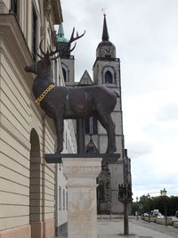 Low angle view of statue against building