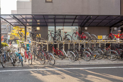 Bicycles parked on road by building